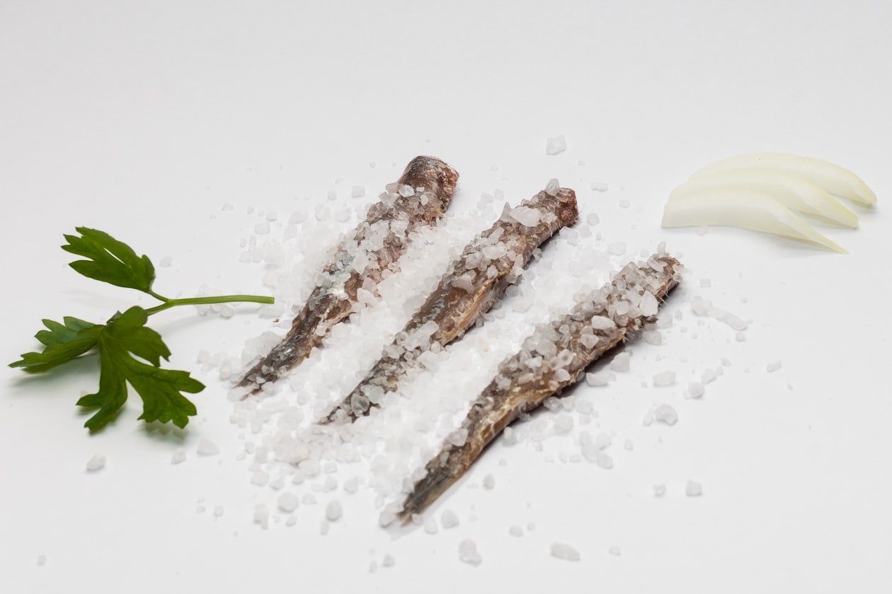 Filetti di baccalà sotto sale grosso con prezzemolo e cipolla